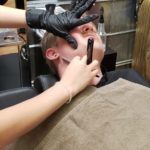 Alex Payne getting straight razor shave at barbershop