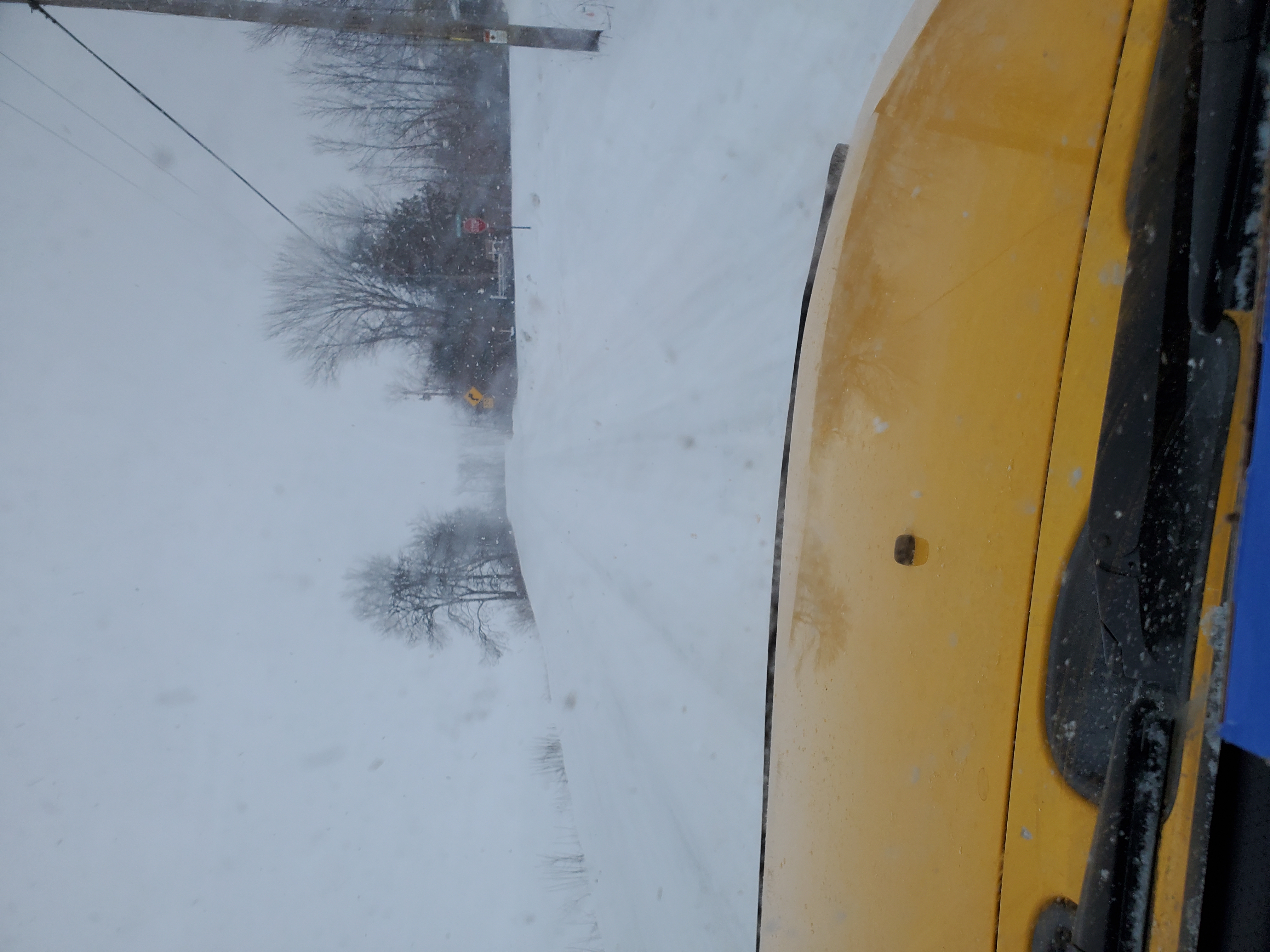 looking out a Yellow FJ's windshield while driving on a snowy road in MIchigan