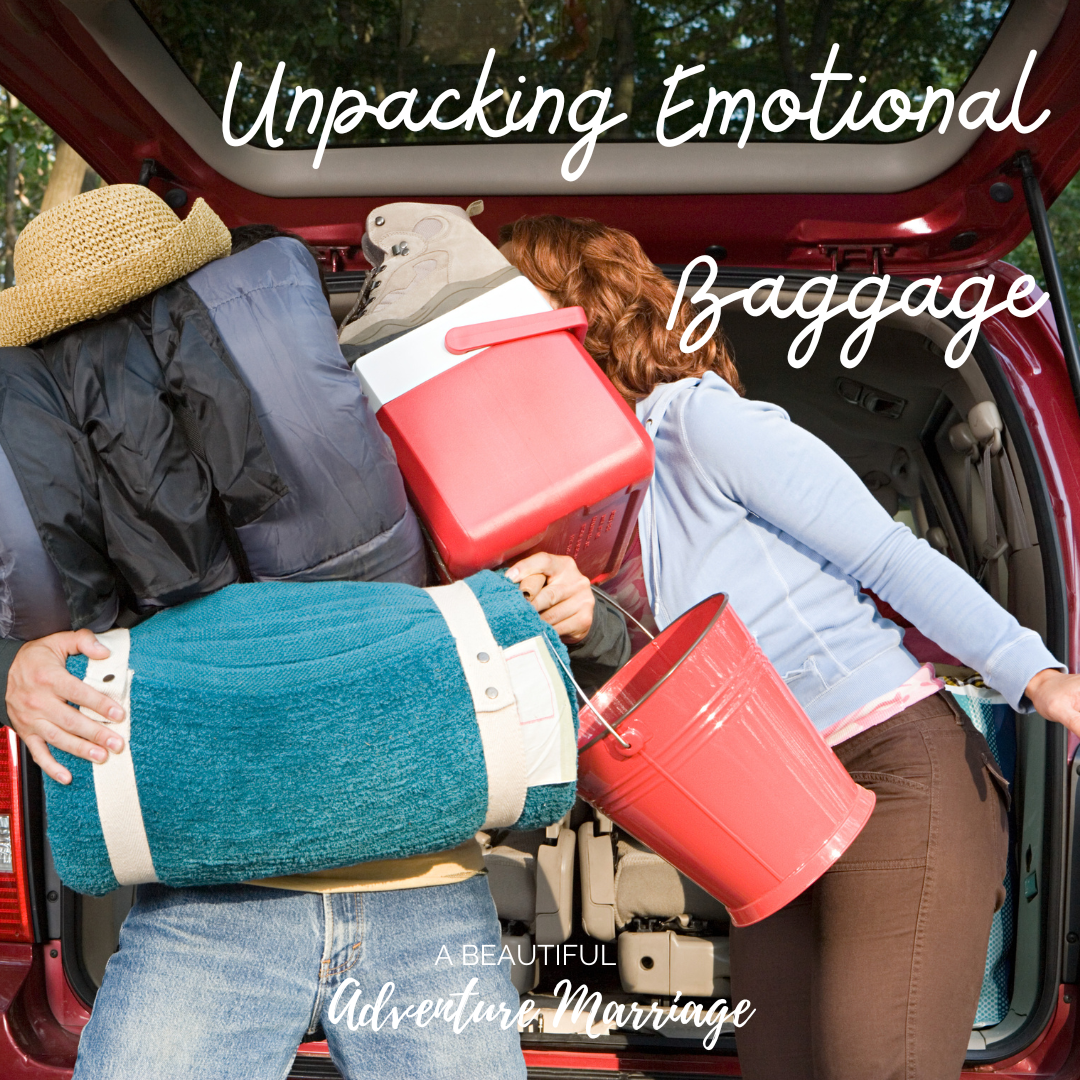 A couple trying to unpack their camping luggage from a car. The husband is holding too many bags and the wife is trying to help.