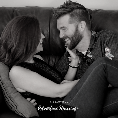 Alex and Tara sitting on a couch laughing